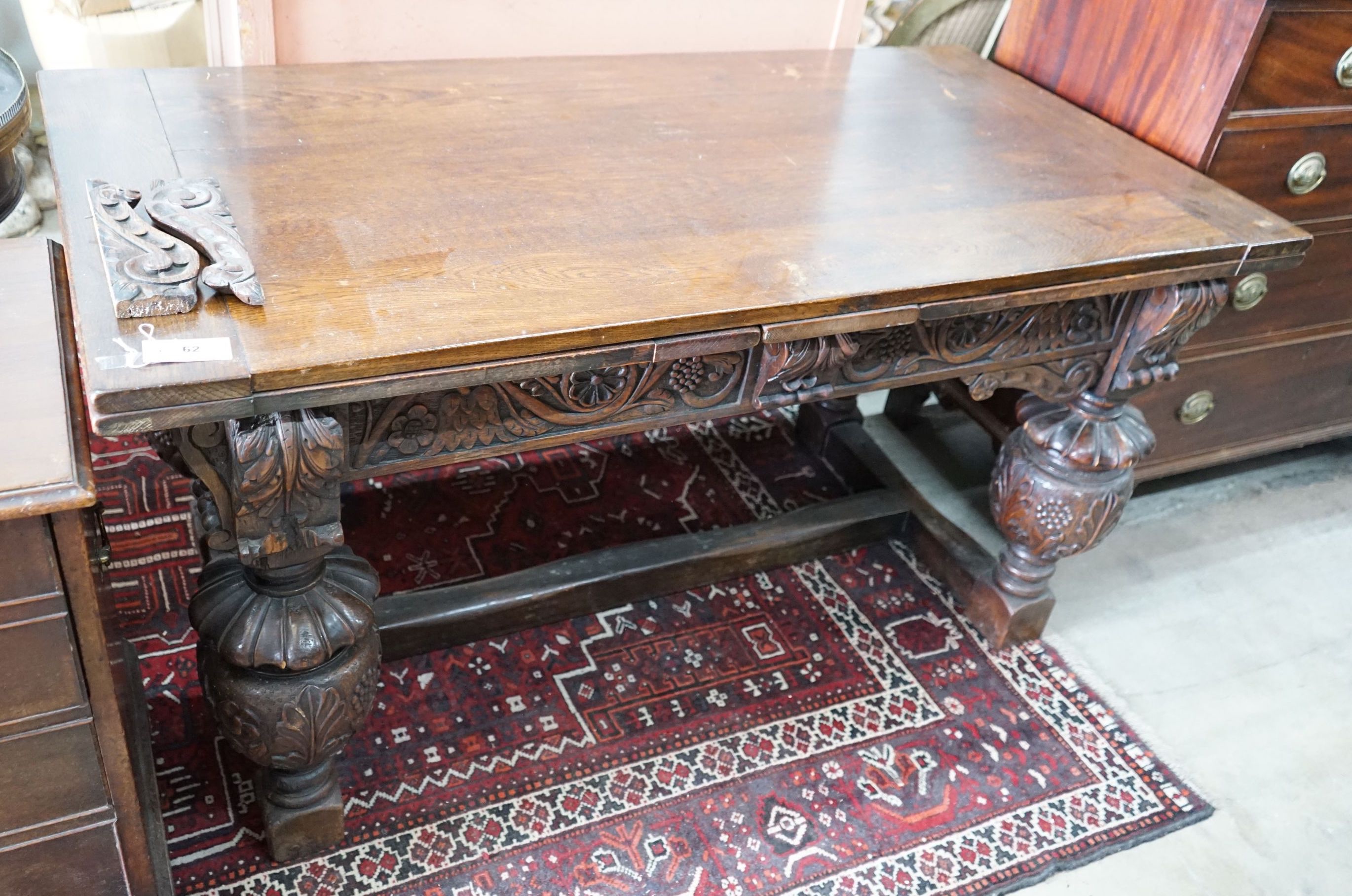 A 17th century style rectangular oak draw leaf dining table on carved baluster legs, 275cm extended, width 76cm, height 77cm